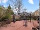 Backyard patio featuring a black iron gazebo and tiered landscaping with mature plantings at 11910 W 83Rd Pl, Arvada, CO 80005
