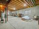 Unfinished basement with exposed ceiling, concrete walls, and natural light from windows at 11910 W 83Rd Pl, Arvada, CO 80005