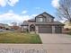 Attractive exterior showcases stone accents, a well-kept lawn, and an inviting entrance at 11910 W 83Rd Pl, Arvada, CO 80005