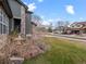 Inviting front yard with lush green lawn, mature trees, rock outcroppings and updated home exterior at 11910 W 83Rd Pl, Arvada, CO 80005