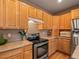 Galley kitchen featuring stainless steel appliances, plentiful cabinets, and light countertops at 11910 W 83Rd Pl, Arvada, CO 80005