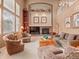 Living room with a fireplace and abundant natural light at 11910 W 83Rd Pl, Arvada, CO 80005