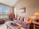 Inviting living room with comfortable seating, a large window, and cozy decor at 11910 W 83Rd Pl, Arvada, CO 80005