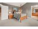 Comfortable bedroom boasts a four-poster bed, bedside table, and ensuite bathroom access at 11910 W 83Rd Pl, Arvada, CO 80005