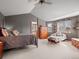 A bedroom boasts high ceilings, a four-poster bed, a cozy chair, and natural light at 11910 W 83Rd Pl, Arvada, CO 80005