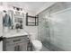 This updated bathroom offers a glass shower, white subway tile, and gray vanity at 3730 Lowell Blvd, Denver, CO 80211