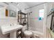 Bright, clean bathroom featuring a pedestal sink, subway tile, and updated fixtures at 3730 Lowell Blvd, Denver, CO 80211