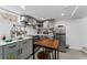 This kitchen features gray cabinets, stainless steel appliances, eat-in counter, and natural light at 3730 Lowell Blvd, Denver, CO 80211