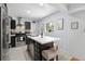 Well-lit kitchen with stainless steel appliances, a quartz island with seating, and stylish modern accents at 3730 Lowell Blvd, Denver, CO 80211
