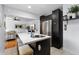 Bright kitchen with modern island featuring bar seating, stainless appliances, and an open living space at 3730 Lowell Blvd, Denver, CO 80211