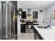 Updated kitchen featuring stainless steel appliances, dark cabinetry, and a sleek modern design at 3730 Lowell Blvd, Denver, CO 80211