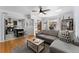 Open-concept living room with hardwood floors, a gray sofa, and kitchen view creates a welcoming space at 3730 Lowell Blvd, Denver, CO 80211