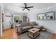 Well-lit living room with hardwood floors, a gray sectional sofa, and a functional workstation at 3730 Lowell Blvd, Denver, CO 80211