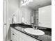 Bathroom featuring granite countertops, white cabinets, and a large mirror at 2188 Abigail Ln, Castle Rock, CO 80104