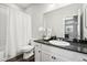 Updated bathroom boasts shower and tub, vanity with dark countertop and white cabinets at 2188 Abigail Ln, Castle Rock, CO 80104