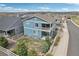 Two-story blue home boasts second-floor balcony, white fence, and a well-manicured lawn at 2188 Abigail Ln, Castle Rock, CO 80104