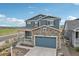 Charming two-story home featuring a stone facade, attached garage, and well-maintained landscaping at 2188 Abigail Ln, Castle Rock, CO 80104