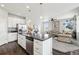 Modern kitchen with stainless steel appliances, granite counters, island, and open floor plan to the living room at 2188 Abigail Ln, Castle Rock, CO 80104