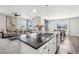 Island kitchen with an open design, modern finishes, and views into the living and dining areas at 2188 Abigail Ln, Castle Rock, CO 80104