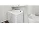Laundry room with white washer and dryer, and a utility sink at 2188 Abigail Ln, Castle Rock, CO 80104