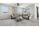 Bright living room with neutral carpet, large windows, and comfortable seating arrangement at 2188 Abigail Ln, Castle Rock, CO 80104