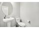 Stylish half bathroom with a pedestal sink, commode and light neutral paint at 2188 Abigail Ln, Castle Rock, CO 80104