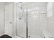 Bathroom shower featuring white tiled walls, a glass door, and bench seating at 2188 Abigail Ln, Castle Rock, CO 80104