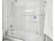 Bathroom shower featuring a tub with white tiled walls, and a glass door at 2188 Abigail Ln, Castle Rock, CO 80104
