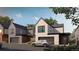 Modern two-story home featuring a garage, minimalist design, and a well-manicured lawn at 625 Lombardi Cir, Louisville, CO 80027