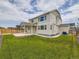 A spacious backyard featuring a well-maintained lawn and a covered patio area at 11657 Olathe St, Commerce City, CO 80022
