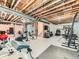 Spacious unfinished basement with exposed ceiling and a home gym in progress at 11657 Olathe St, Commerce City, CO 80022