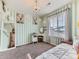 Stylish bedroom with chic chandelier, deer artwork, and striped accent wall at 11657 Olathe St, Commerce City, CO 80022