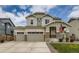 Two-story home with three-car garage, stone accents, landscaped front yard, and an American flag at 11657 Olathe St, Commerce City, CO 80022