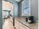 This kitchen showcases granite countertops, white cabinets, and a coffee bar by the window at 11657 Olathe St, Commerce City, CO 80022