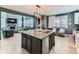 Open-concept kitchen with a large island, granite countertops, and stainless-steel appliances at 11657 Olathe St, Commerce City, CO 80022