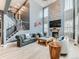 Chic living room with stone fireplace, vaulted ceiling, and elegant finishes creates a cozy atmosphere at 11657 Olathe St, Commerce City, CO 80022