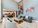Spacious living room boasts tall ceilings, hardwood floors, a modern chandelier, and an open floor plan at 11657 Olathe St, Commerce City, CO 80022
