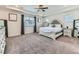 Large main bedroom with plush carpeting, tray ceiling, and abundant natural light at 11657 Olathe St, Commerce City, CO 80022