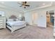 Bright main bedroom featuring neutral walls, carpet, and a tray ceiling at 11657 Olathe St, Commerce City, CO 80022