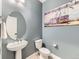 Stylish powder room featuring trendy graffiti art, a modern vessel sink, and sleek fixtures at 11657 Olathe St, Commerce City, CO 80022