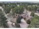 Wide aerial view showcases the wooded lot including home, barn, and driveway at 12493 Forest Canyon Dr, Parker, CO 80138