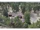 Drone shot offering a serene view of the home nestled amongst lush green trees at 12493 Forest Canyon Dr, Parker, CO 80138