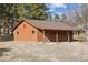 Exterior view of a well-maintained barn with a covered porch and wooden construction at 12493 Forest Canyon Dr, Parker, CO 80138