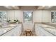 Bathroom with double vanities, natural light and view of trees at 12493 Forest Canyon Dr, Parker, CO 80138