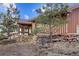 Exterior view of home featuring wooded backyard, stone retaining wall and mature trees at 12493 Forest Canyon Dr, Parker, CO 80138