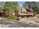 Charming house surrounded by mature trees, large windows, and an open deck at 12493 Forest Canyon Dr, Parker, CO 80138