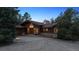 Charming front exterior of a home with a well-lit entrance and landscaped yard at dusk at 12493 Forest Canyon Dr, Parker, CO 80138