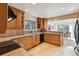 Well-lit kitchen featuring wood cabinets, granite countertops, and stainless steel appliances at 12493 Forest Canyon Dr, Parker, CO 80138