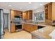 Classic kitchen with stainless steel appliances, granite countertops, and custom wood cabinetry at 12493 Forest Canyon Dr, Parker, CO 80138