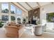 Bright living room featuring large windows, a cozy fireplace, and comfortable seating at 12493 Forest Canyon Dr, Parker, CO 80138